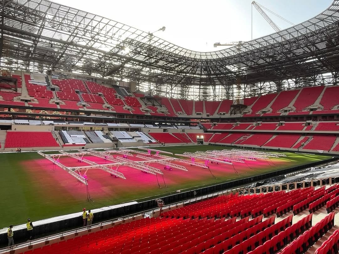 Interior view of Moulay abdellah stadium in Rabat under construction for CAN 2025, with red seats and grow lights on the pitch. Source: @FRMFXtra on X.