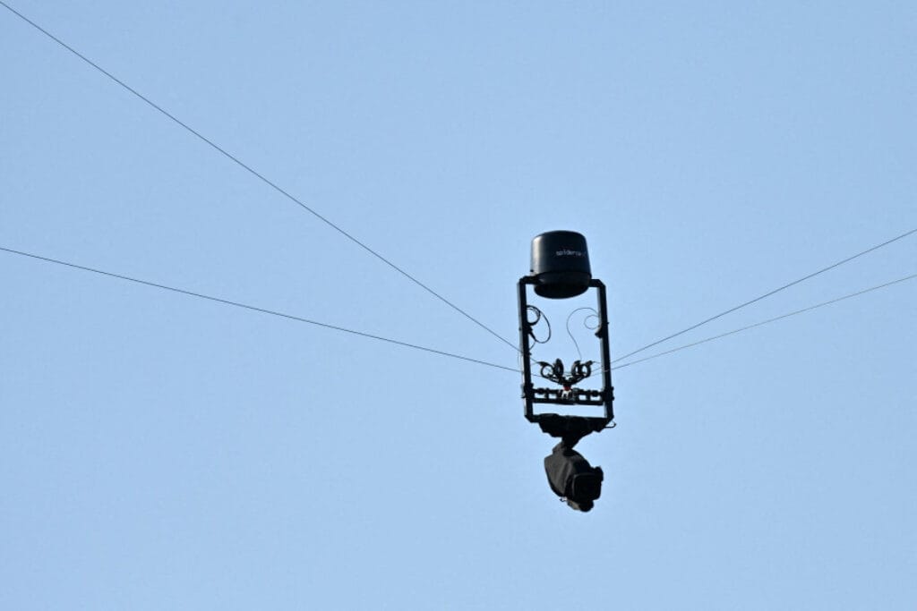Close-up of a Spidercam suspended above a football stadium during a match, symbolizing Morocco’s AFCON 2025 broadcast technology upgrades.