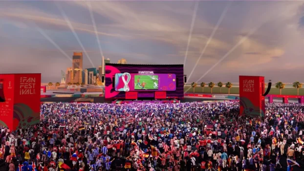 Fans celebrating at AFCON Morocco 2025 Fan Zone with flags and music.
