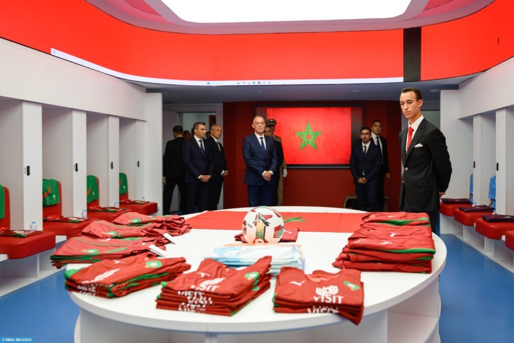 Prince Moulay El Hassan stands inside a Moroccan football locker room
