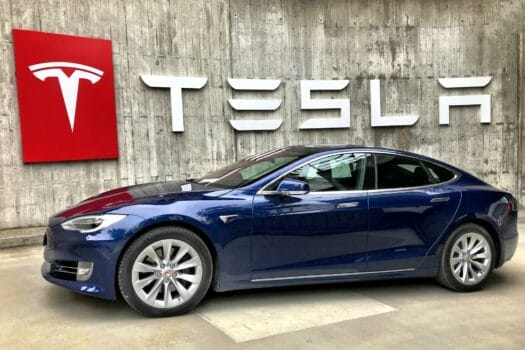 Tesla electric car in front of company logo, representing Morocco’s role as Africa’s gateway to sustainable mobility.