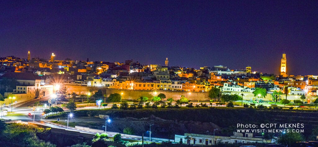 Night panoramic view of Meknès Medina with illuminated walls and towers in Morocco