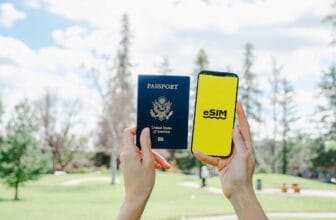 Hands holding a U.S. passport and a smartphone showing an eSIM screen, illustrating digital SIM use for easier travel in Morocco.