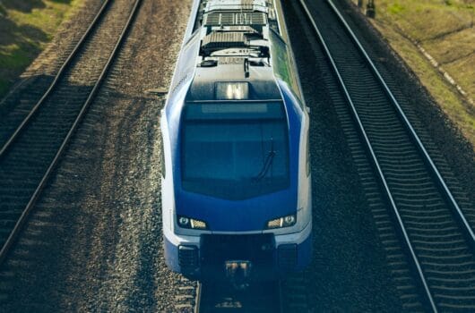 Modern blue electric train on double tracks representing Morocco’s ONCF and Hyundai Rotem railway modernization project