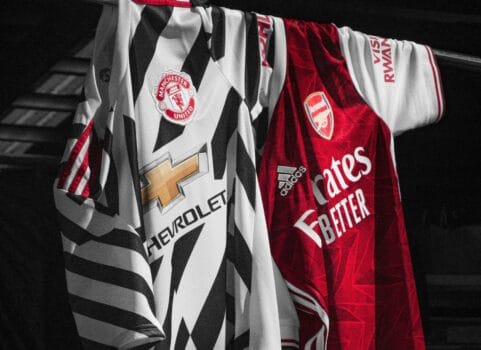 Manchester United and Arsenal football shirts hanging side by side, symbolizing Premier League teams impacted by AFCON 2025.