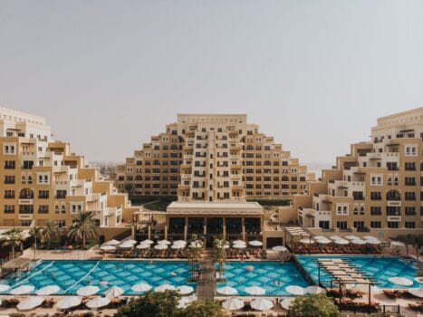 Rixos Bab Al Bahr resort on Al Marjan Island with pyramid-style architecture and large outdoor pools under the sun