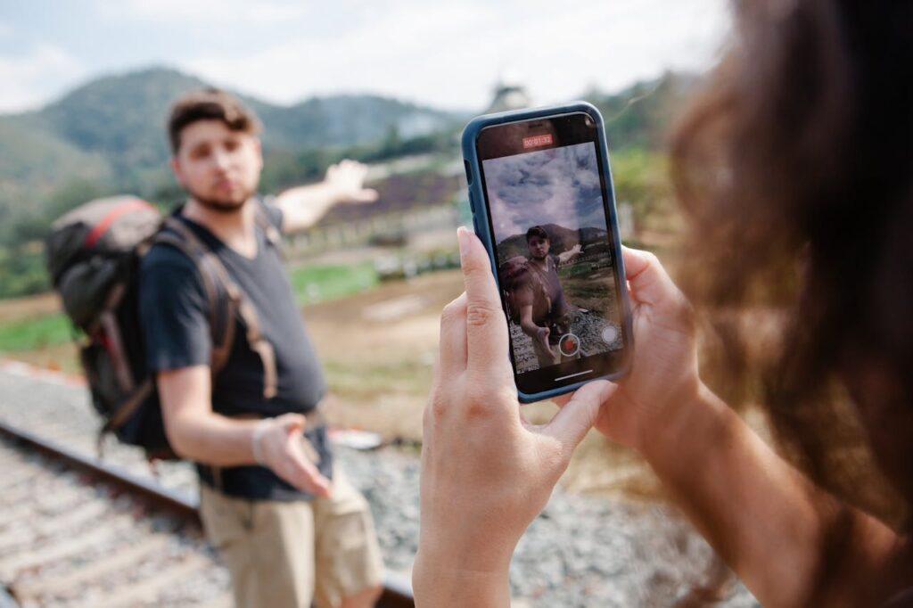 A traveler recording a video on a smartphone while exploring outdoors