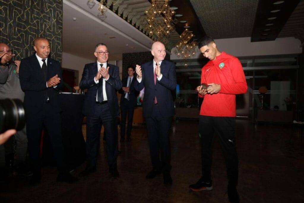 Achraf Hakimi receiving FIFA The Best Starting 11 trophy during ceremony in Morocco