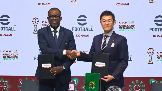 CAF representatives and a KONAMI executive shaking hands during the official signing of the AFCON 2025 gaming sponsorship agreement.