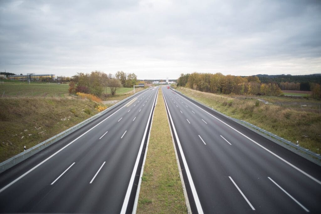 A wide multi-lane highway stretching into the distance, photographed from above, symbolizing efficient national transport and smooth inter-city mobility.