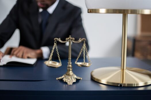 Scales of justice on a desk symbolizing on-site judicial procedures during AFCON matches in Morocco.