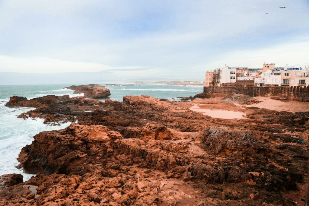 Rocky Atlantic coastline of Essaouira with ocean waves and historic seaside buildings