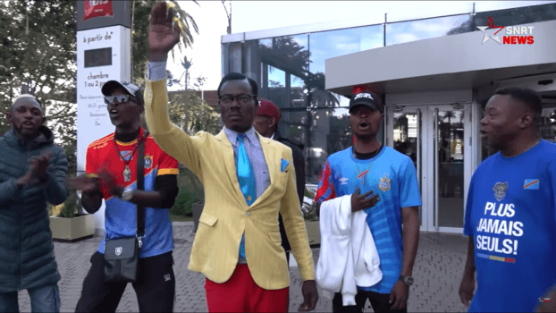 DR Congo supporter known as Lumumba standing still and saluting outside the stadium during CAN 2025 in Morocco