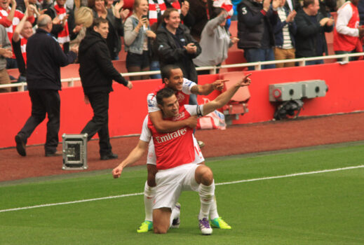 Robin van Persie celebrating a goal with Arsenal, father of Shaquil van Persie