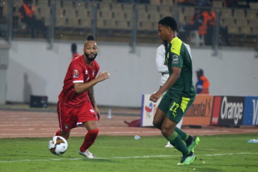 Veteran African footballer dribbling during an Africa Cup of Nations match