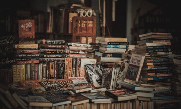 Stacks of books arranged on tables and shelves inside a small independent bookshop