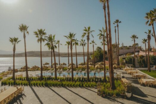 Lalla Takerkoust Lake near Marrakech with palm trees, pool terrace, and Atlas foothills in the background