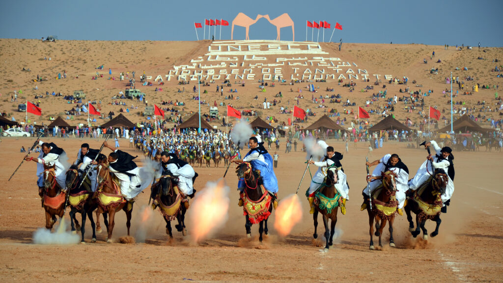 Horse riders performing fantasia during the Tan-Tan Moussem in southern Morocco