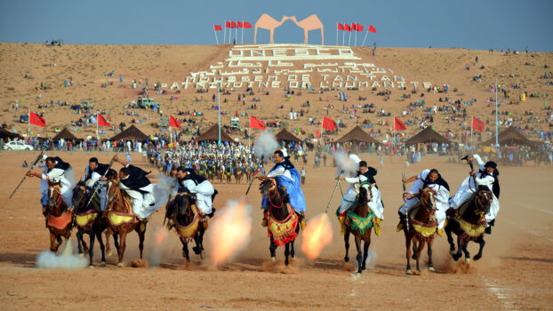 Horse riders performing fantasia during the Tan-Tan Moussem in southern Morocco